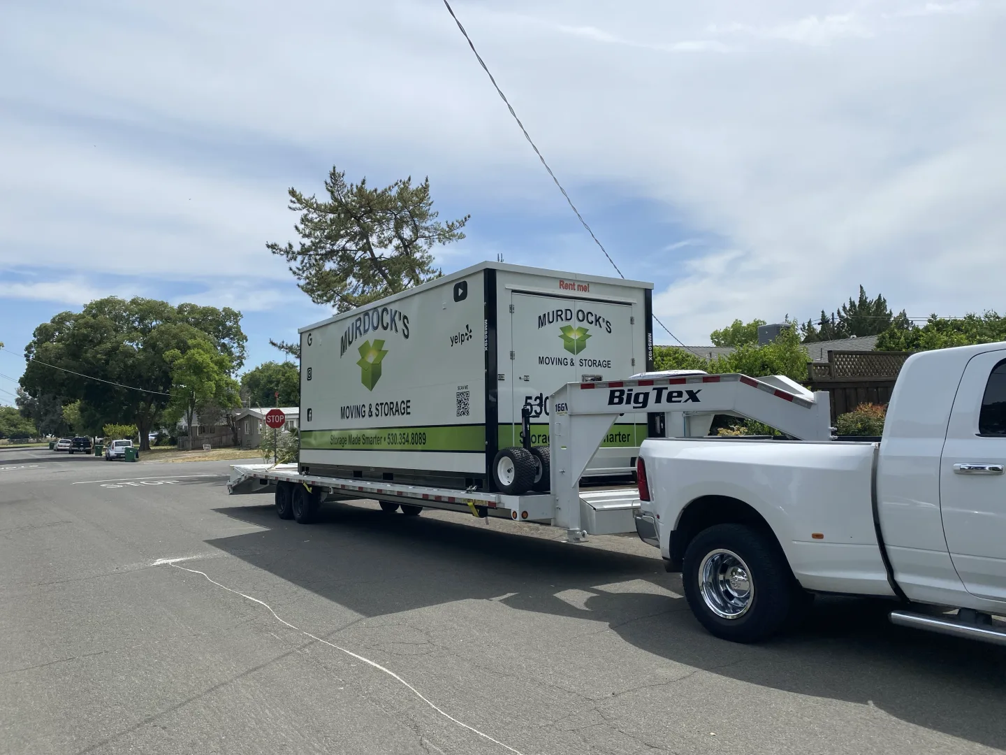 A loaded container hauled on Murdock’s own trailer between addresses.