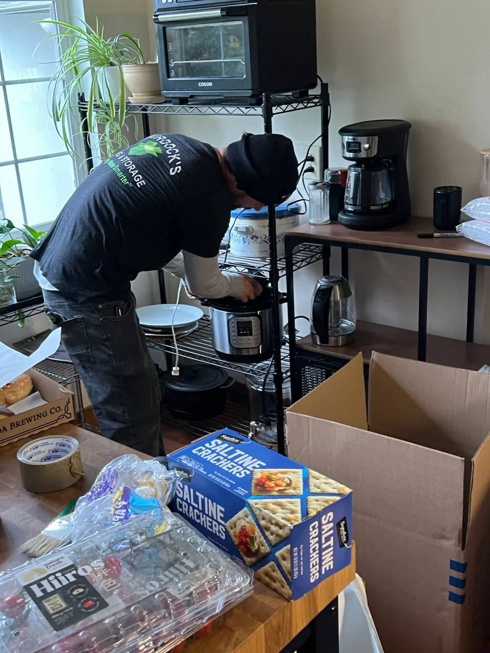 Murdock’s mover professionally packing household items in a kitchen