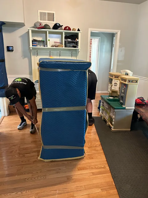 Murdock’s mover protecting padded furniture inside a home
