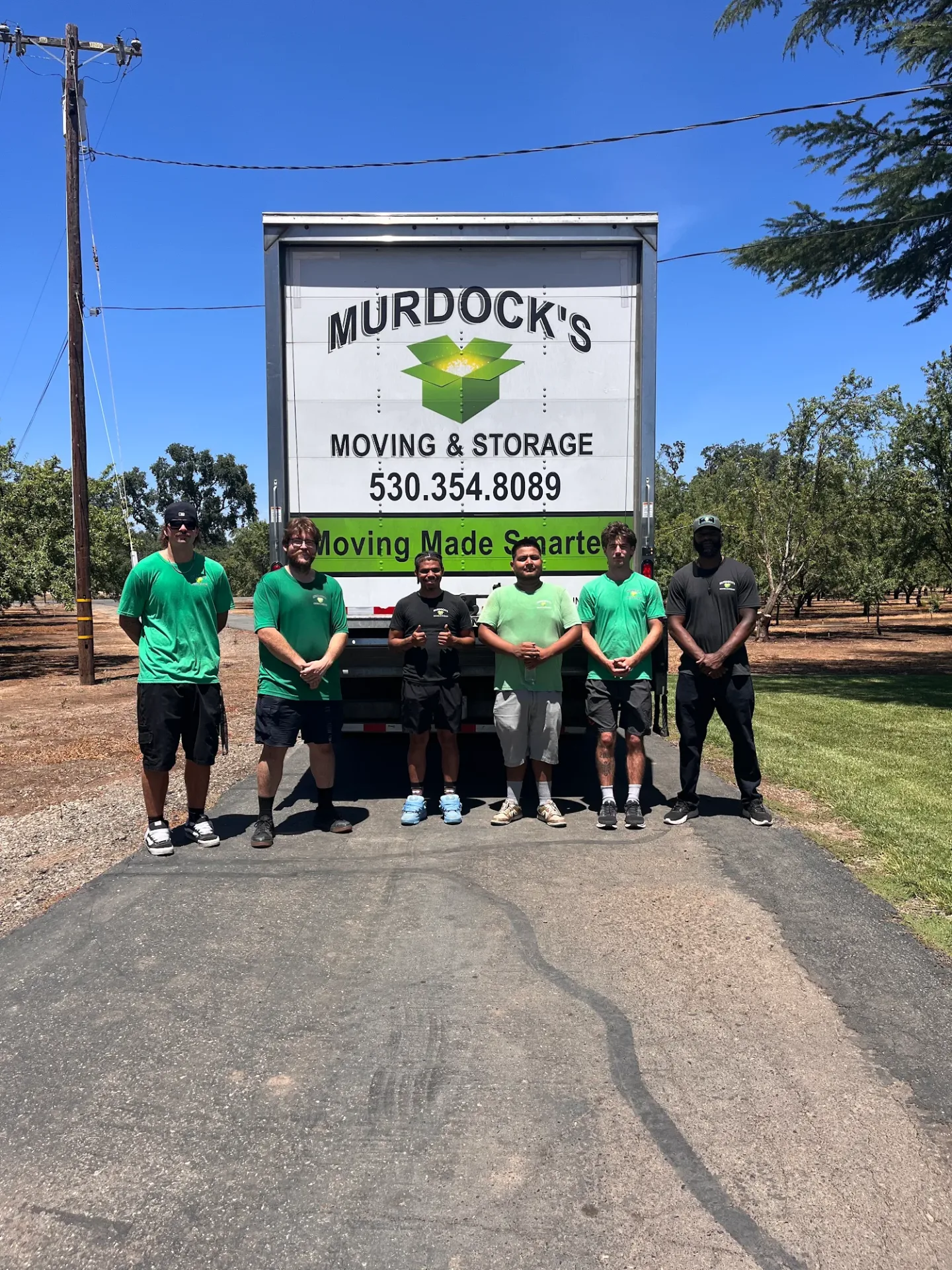 Murdock’s full moving crew beside a branded truck